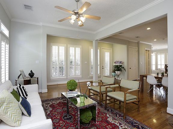 With an open floor plan, the dining and living area is adorned with numerous windows flooding the ro