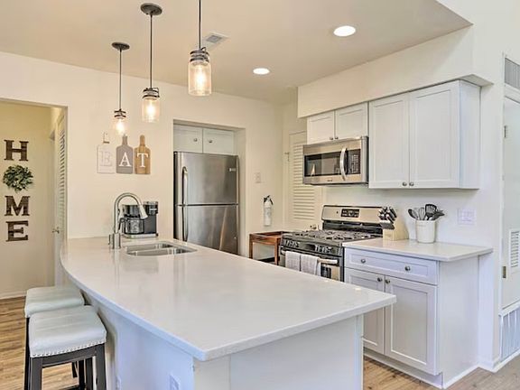 updated kitchen with stainless steel appliances, gas cooking, and dishwasher