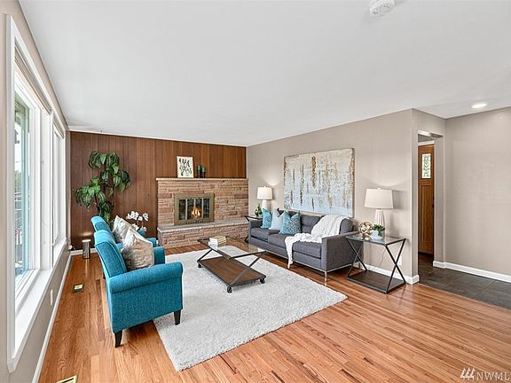 Gleaming Hardwoords in the Upper Living Area Great Room with Natural Gas Insert combine with Warm Woodtones to set the mood in t