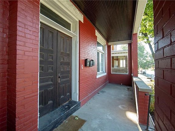ENTRANCE TO UNITS 2 AND 3 WITH INVITING, PARTIALLY ENCLOSED FRONT PORCH FOR  RELAXING AND ENTERTAINING.  BUS STOP IS LOCATED JUS
