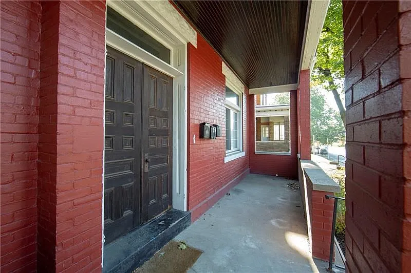 ENTRANCE TO UNITS 2 AND 3 WITH INVITING, PARTIALLY ENCLOSED FRONT PORCH FOR  RELAXING AND ENTERTAINING.  BUS STOP IS LOCATED JUS