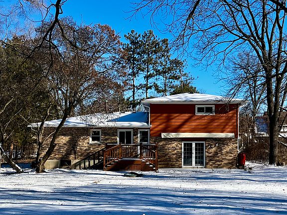 View of the back of the house in the snow.