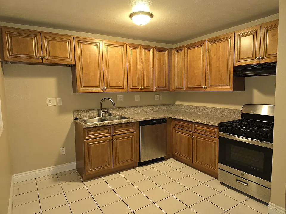 Kitchen has been remodeled and includes stainless steel dishwasher and oven/range.
