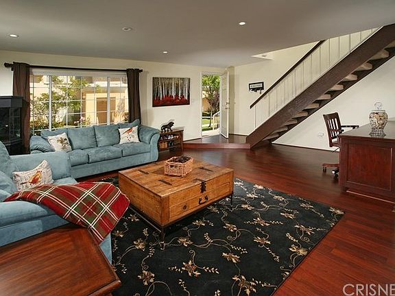 The spacious living room is drenched in natural li