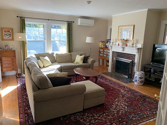 Huge sunny living room with mantle and working fireplace.