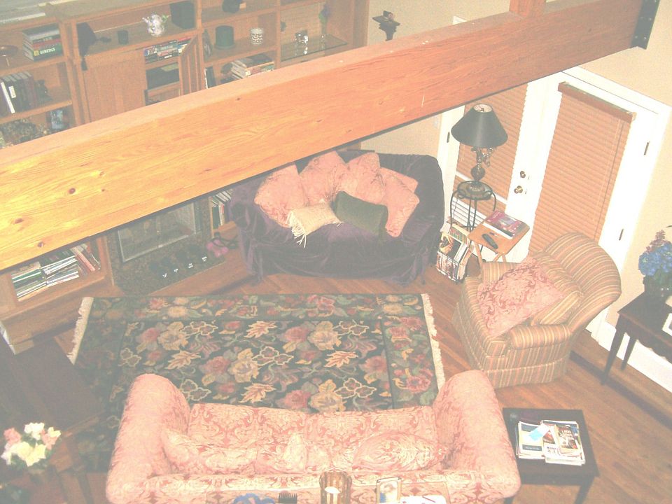 Exposed Beam lofted area in top apartment.  Open living space