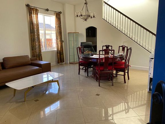 Bright, open living room with upgraded tiles and natural light.