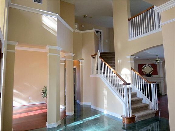 View of front stairwell upon entering home,