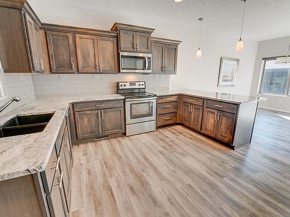 The kitchen, including a microwave, oven, and refrigerator