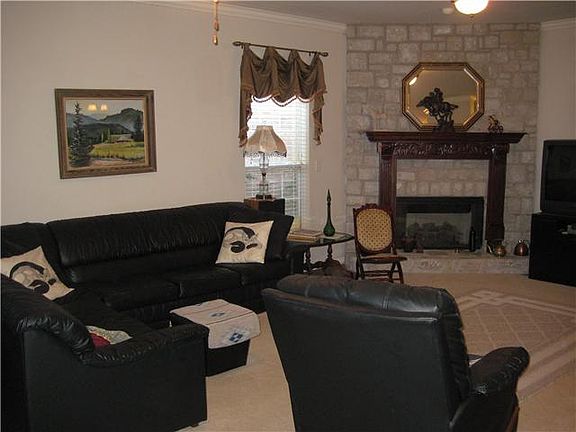 Living with angled Fireplace, rich wood mantle, Neutral walls