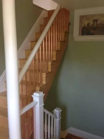 Stairwell down to entry door and up to the bedrooms.
Walls are painted all white.