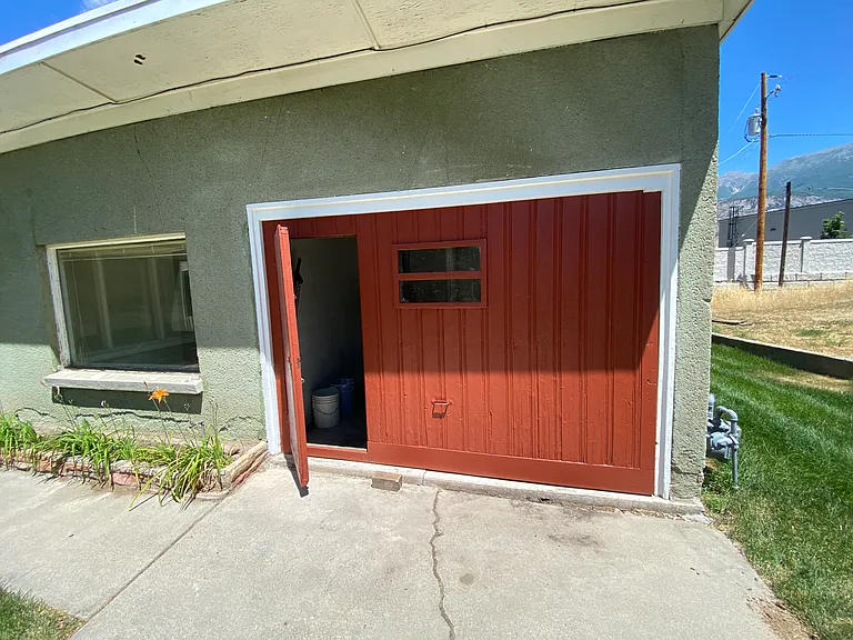Garage Door: Newly painted original vintage wood door with a smaller door to get inside the garage and house.