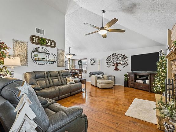 Vaulted ceilings and hardwood floors offer space and warmth.