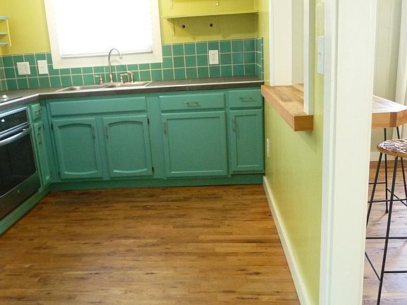 Kitchen with pass-thru opening & bar to dining area. Brand new oven, freshly painted cabinets.