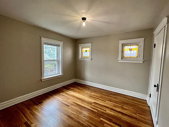 Bedroom with large closet, fresh paint, new flooring, new light fixture and stained glass windows