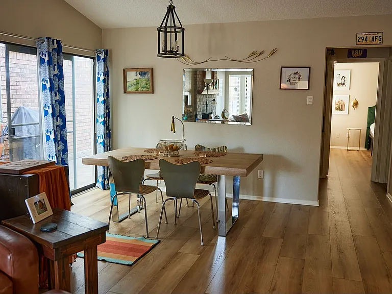 Dining room with light wood finished floors and vaulted ceiling