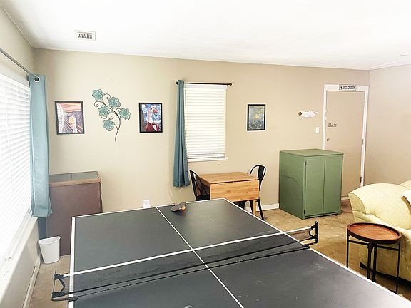 Game room with ping pong table, games, books, and TV