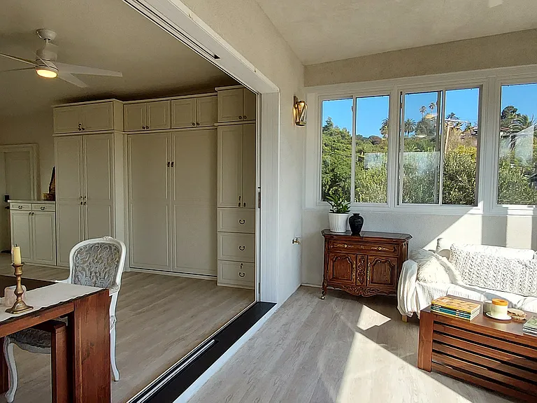 Open to open the giant glass tri-slider or close it to create 2 separate rooms. Wall to ceiling black out curtains have been added since photos on all 4 walls of the sun room.
