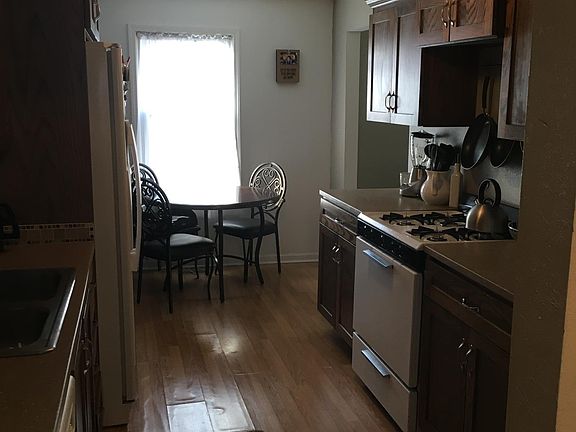 Kitchen from door from Garage and laundry room - Gas Range - Dishwasher - Frig with indoor ice/water. Washer & dryer also furnished in laundry room behind me in photo - Main level laundry thru to Dining room - hall to full bath and 1st floor bedroom to t