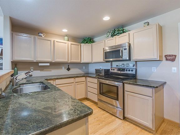 Kitchen Upgraded with Granite Countertops, Hardwood Floors, and Stainless Appliances.
