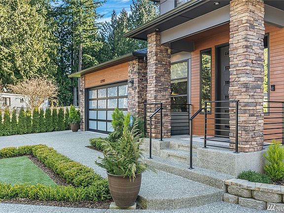 Glass garage doors are very esthetically pleasing.  I love how they make a hoie shine like a lantern at night with the lights on.  Easy care landscaping.