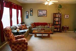 Spacious living room with berber carpet and lots of windows!