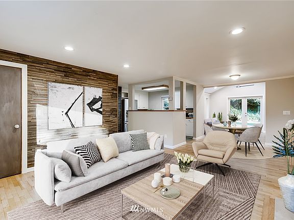 Enter to an easy flow open living space accented with bright LED recessed lighting, hardwood flooring, crown molding and a fun modern wood panel designed wall.