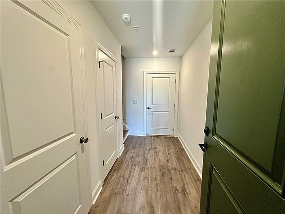 Guest enter from front door with garage directly ahead and laundry and coat closet on the left Phot