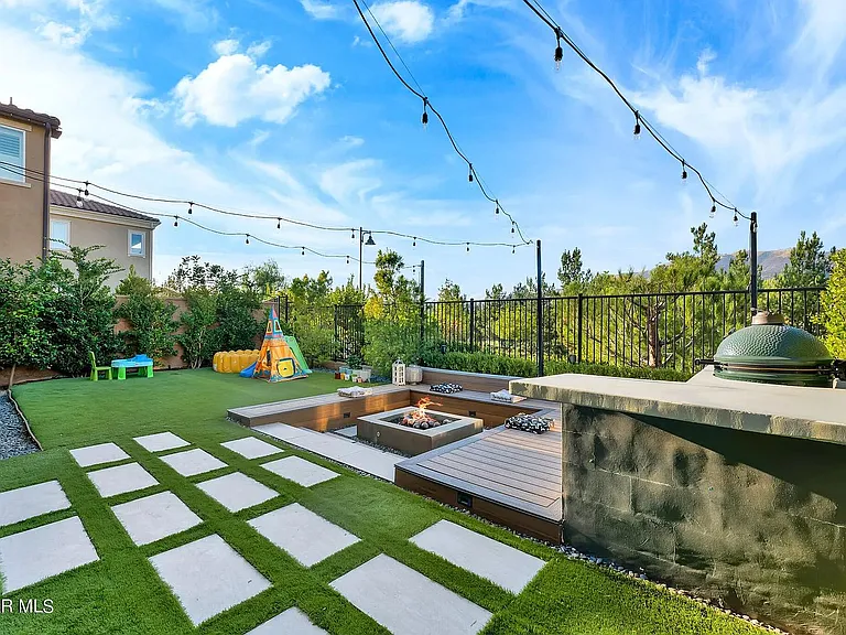 Backyard with deck, firepit, Green Egg and string lights