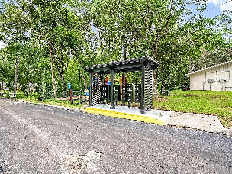 Charming outdoor mailbox pavilion amidst lush greenery, offering convenience and natural beauty.