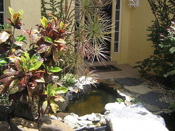 Walk over a charming bridge, waterfalls and koi ponds