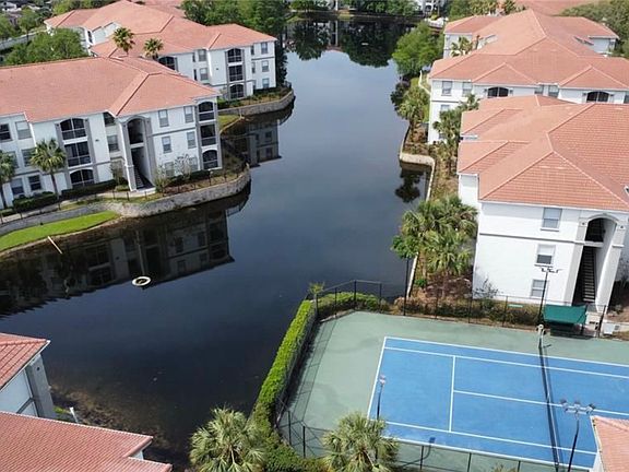 Aerial view of community, pond and tennis court