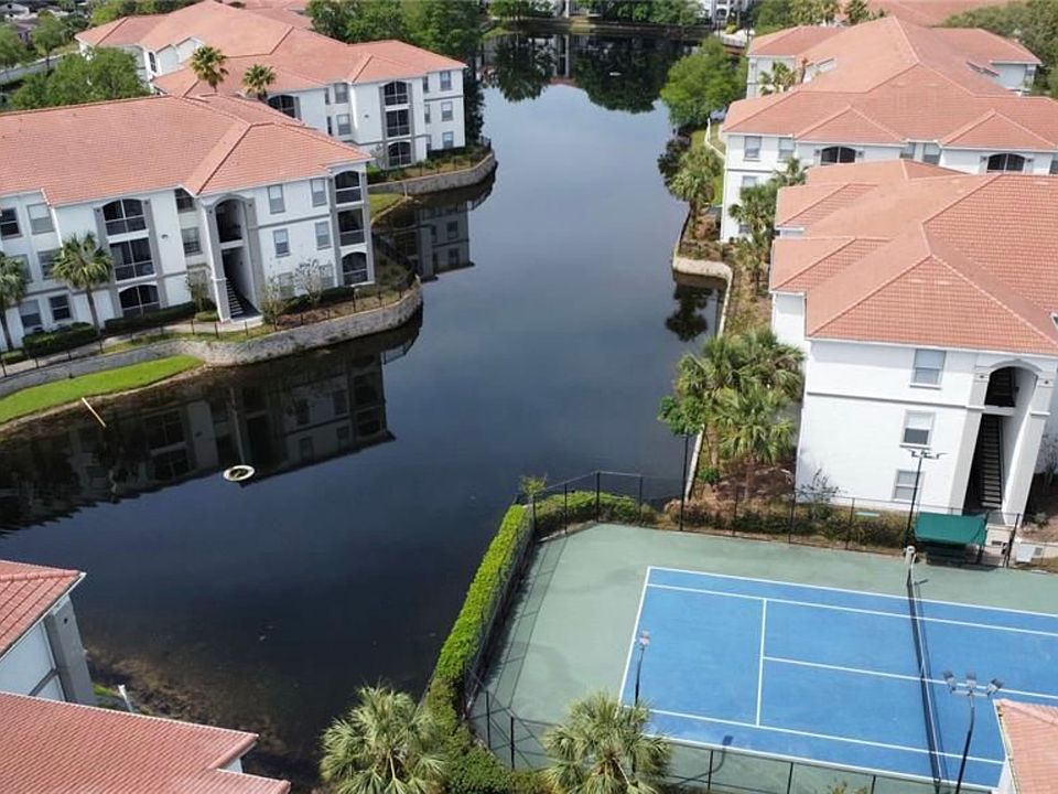 Tennis court in the heart of the complex adjacent to pond.