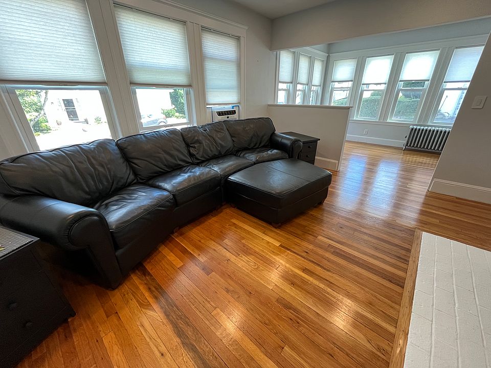 Living room with leather sofa, ottoman and end tables included.