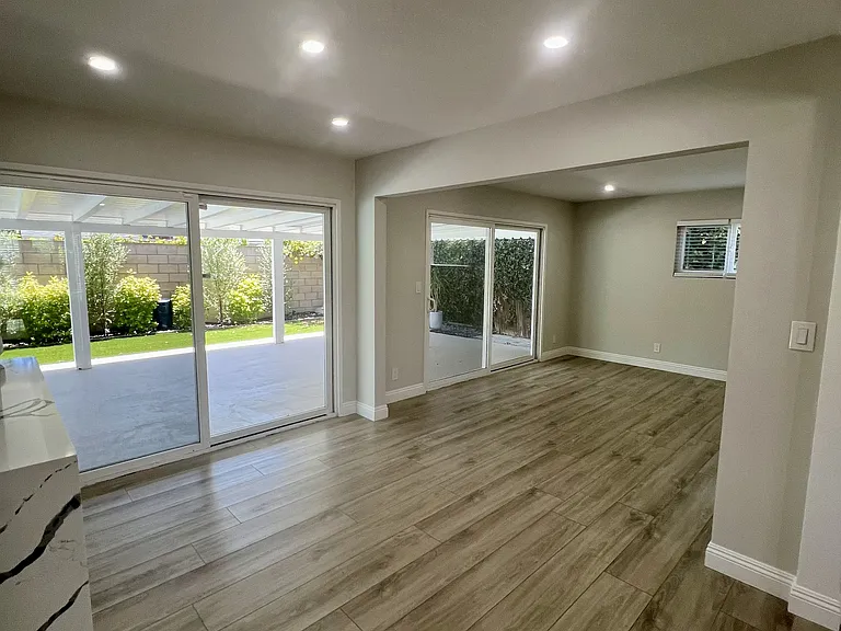 Dining room and den with sliding glass doors to patio and yard