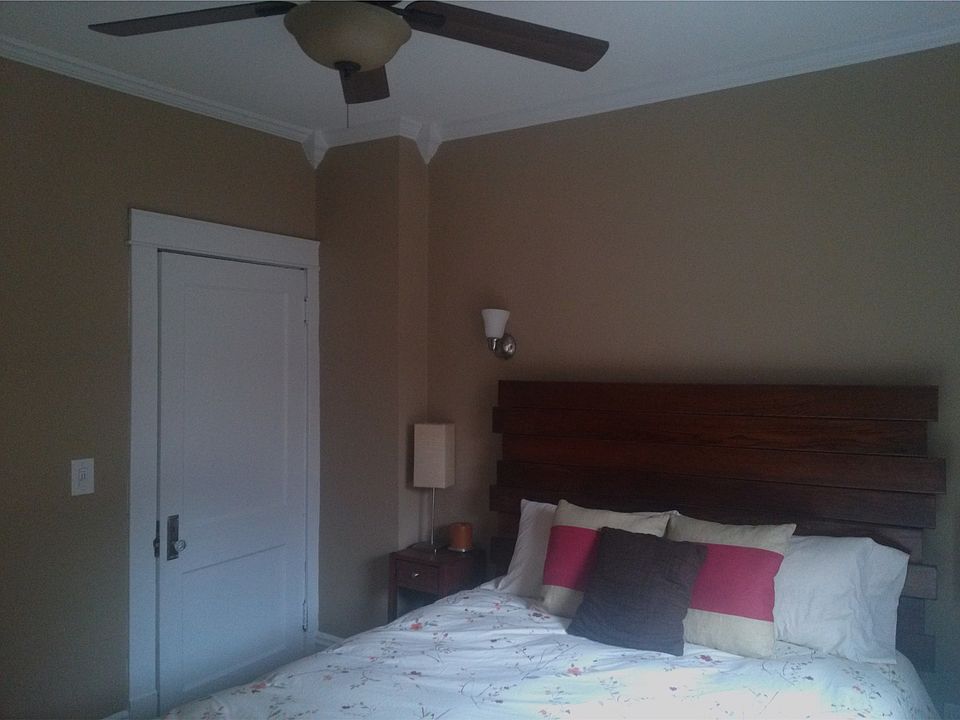 Fully renovated bedroom with crown molding, ceiling fan, and
