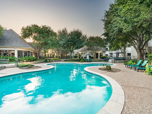 Surrounded by mature trees and thoughtful landscaping, the resort-style pool invites quiet moments or casual conversation poolside.