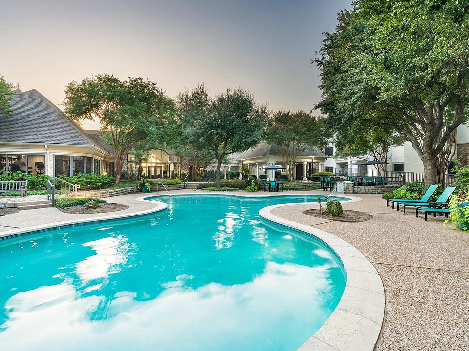 Surrounded by mature trees and thoughtful landscaping, the resort-style pool invites quiet moments or casual conversation poolside.