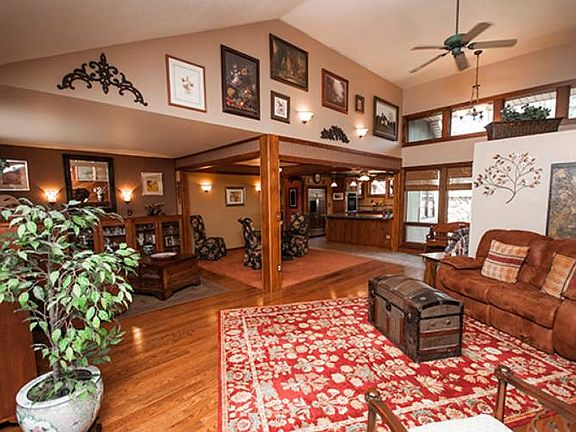 Vaulted ceilings in the living room (24x25) complimented by the red cedar wall and stone fire place.