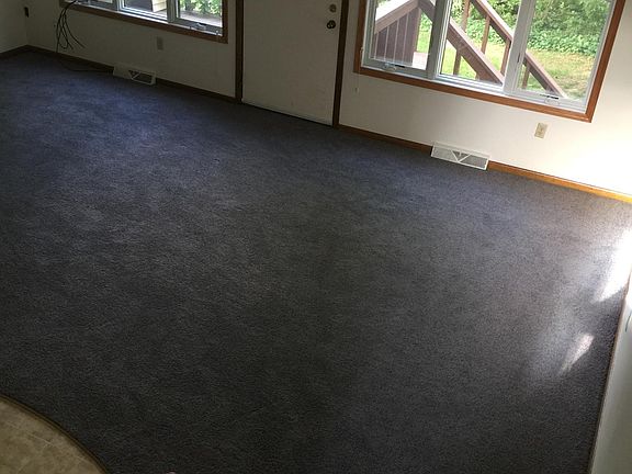 View of the main room and door out to the deck and backyard