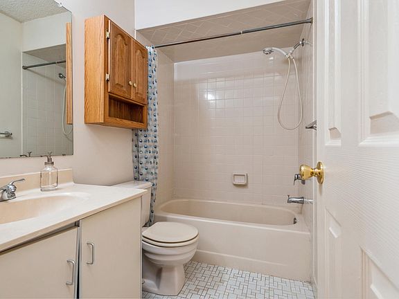 Second floor full bath with tub shower and tile floor.