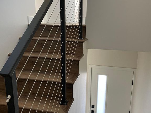 Stairway leading from level 1 to 2. Includes stainless cable rail for a modern design. Upstairs ceilings are 10' high.