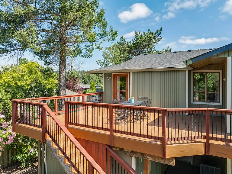 Outside
+Access from kitchen/living room
+Greenhouse (lower right) 
+Dining for 6
+24*20' 
+Trex decking 
+Outdoor lighting 
+1 Ring floodlight camera upstairs by 3rd bdrm door
+2nd Ring floodlight camera located lower level (to the left of the hose)