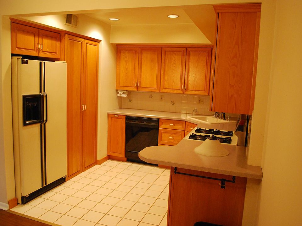 Kitchen. Tile floor, gas range, above range microwave, full size refrigerator, dishwasher, stacked Washer/Dryer (in cabinet to right of refrigerator)