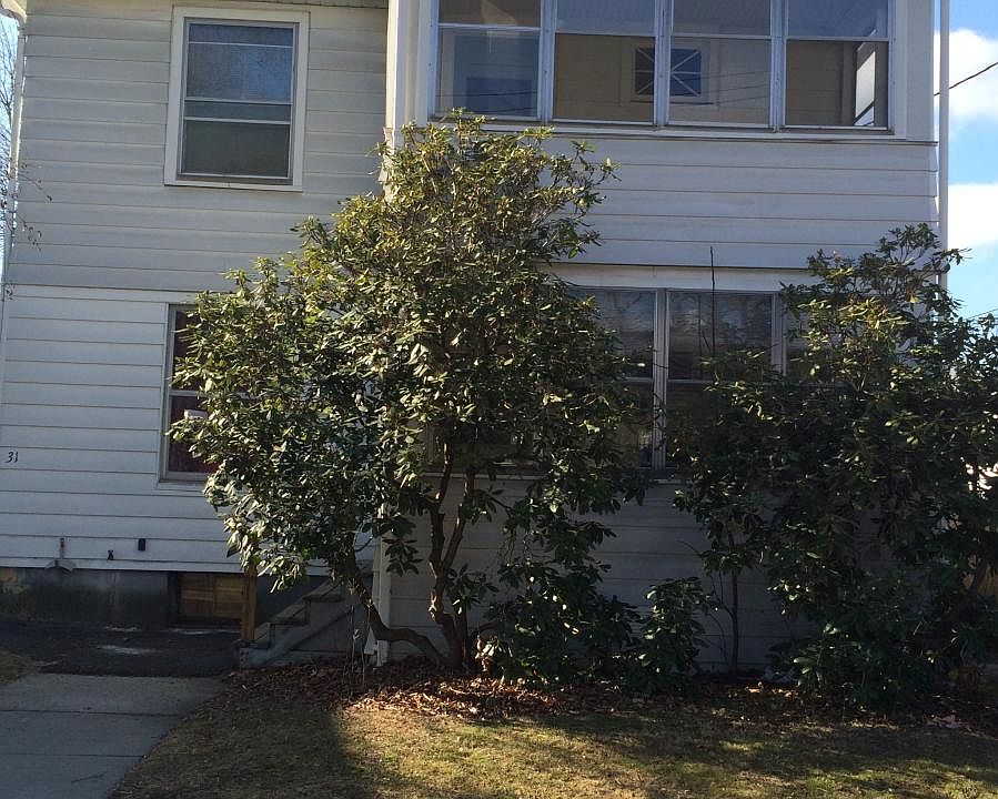 View of house from street, enclosed upstairs porch