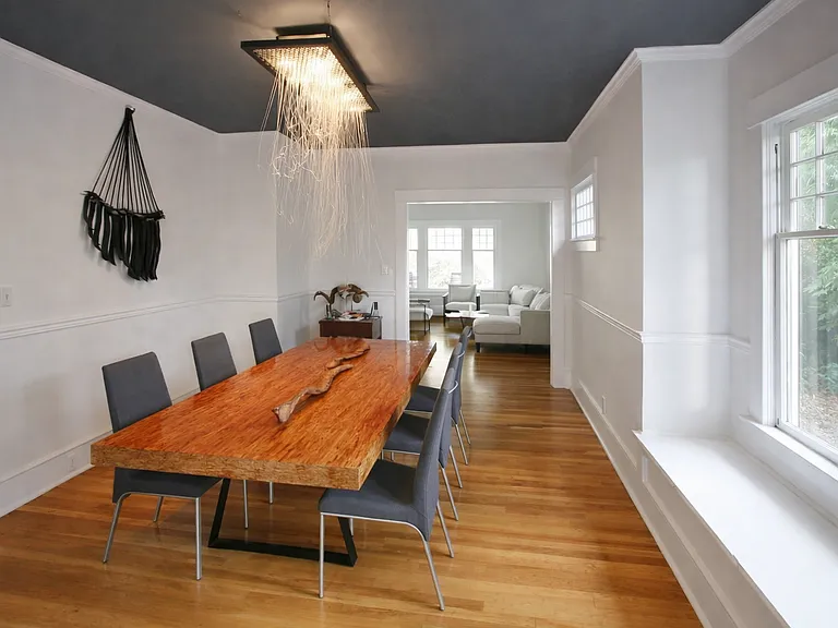 dining room looking East towards living room. South-facing windows on the right. (custom glass art chandelier comes with house)