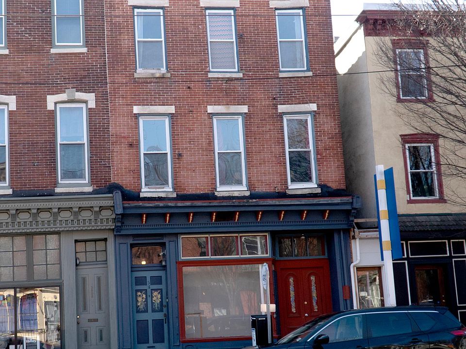 Front of building 
has a window with changing photo exhibits by the owner of the building.