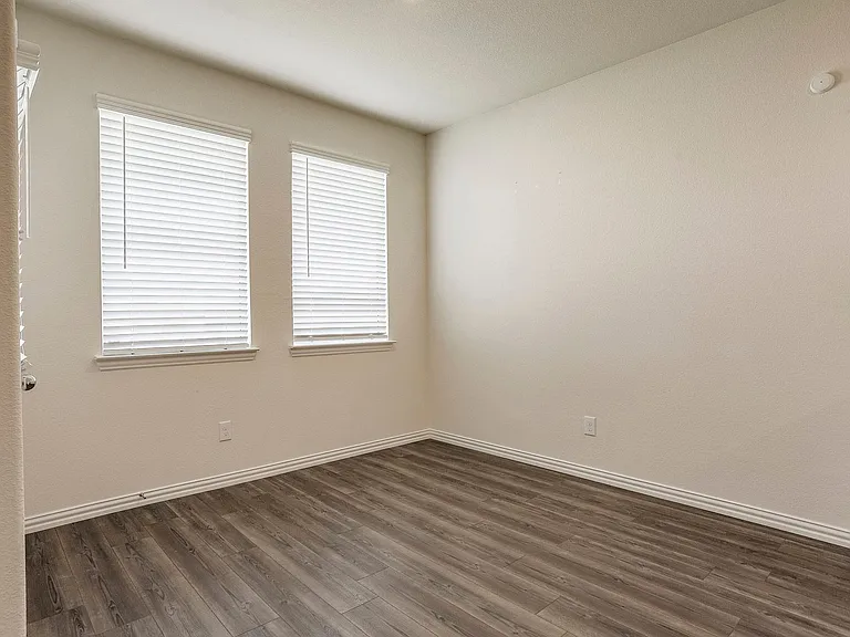 Unfurnished room featuring dark hardwood / wood-style flooring