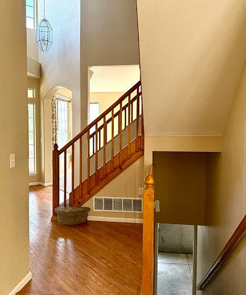 Entryway with stairs leading to the upper level and basement.