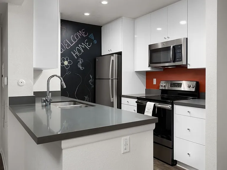 Design Package II Kitchen with quartz countertops stainless steel appliances and hard surface flooring